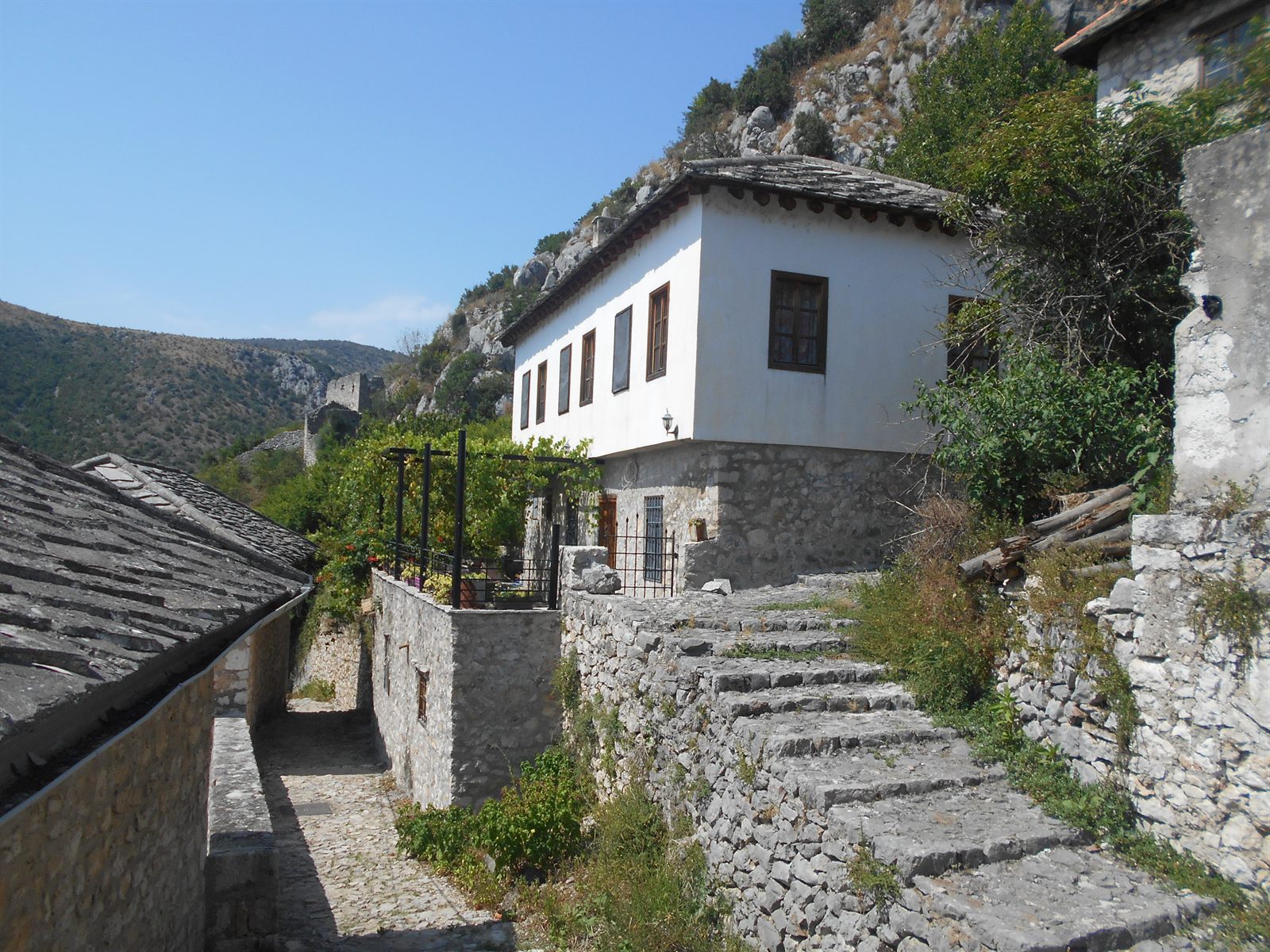 Traditional stone houses beneath the hillside in Počitelj